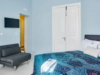 a bedroom with a bed and a chair at Villa Sanyan - Adults Only in Rhodes Town