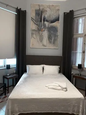 a bedroom with a bed with a white blanket at Villa Sanyan - Adults Only in Rhodes Town