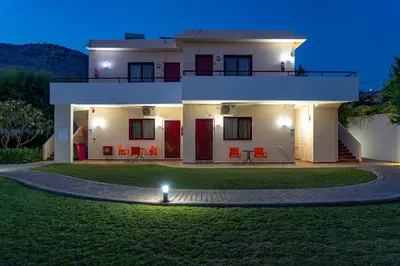 a house with a lawn in front of it at Angela Studios Pefkos in Pefki Rhodes