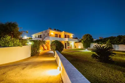 a house with lights on the side of a driveway at Angela Studios Pefkos in Pefki Rhodes