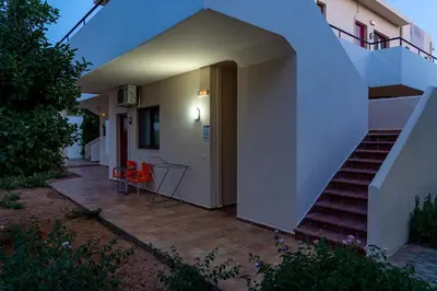 a house with a staircase leading up to a building at Angela Studios Pefkos in Pefki Rhodes