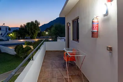 a balcony with a table on the side of a building at Angela Studios Pefkos in Pefki Rhodes
