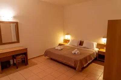 a bedroom with a bed with two towels on it at Angela Studios Pefkos in Pefki Rhodes