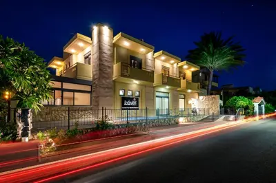 a building at night with lights in the street at Ilyssion Holidays Hotel in Ialyssos