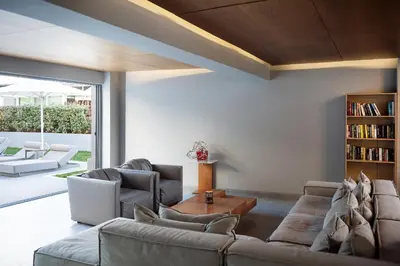 a living room with two couches and a book shelf at Oktober Downtown Boutique Hotel in Rhodes Town