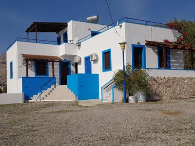 a white and blue house with blue doors at Andreas Studios in Pefki Rhodes