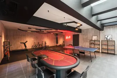 a ping pong room with a ping pong table and chairs at Villa Eleven in Ialyssos