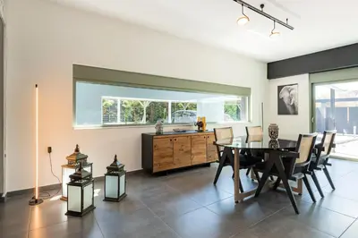 a dining room with a table and some chairs at Villa Eleven in Ialyssos