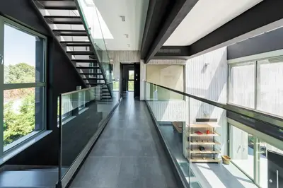 a glass corridor in a building with windows at Villa Eleven in Ialyssos