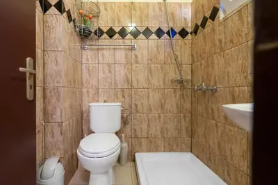 a small bathroom with a toilet and a sink at COLONIAL FAMILY apartment #4 ground floor in Faliraki