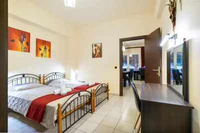 a bedroom with a bed and a desk in it at COLONIAL FAMILY apartment #4 ground floor in Faliraki