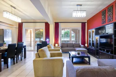 a living room with couches and a dining room at COLONIAL FAMILY apartment #4 ground floor in Faliraki