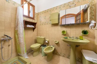 a bathroom with a toilet and a sink and a shower at Villa Agia Galini in Archangelos