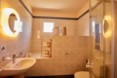 a bathroom with a sink and a toilet at Edem Paradise in Plimmiri