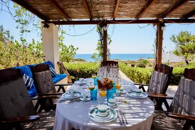 a table with a white table cloth on a patio at Edem Paradise in Plimmiri