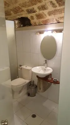 a bathroom with a toilet and a sink at Suite Grand Maitre Rodos in Rhodes Town