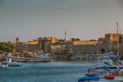 a group of boats docked in a harbor with a castle at Suite Grand Maitre Rodos in Rhodes Town