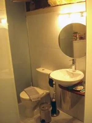 a bathroom with a sink and a toilet and a mirror at Suite Grand Maitre Rodos in Rhodes Town