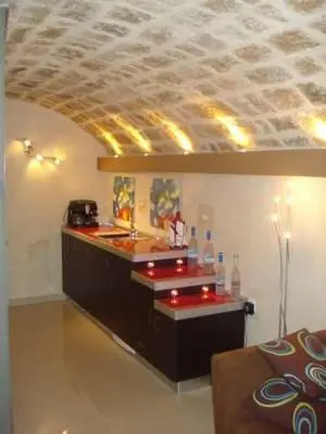 a bar with a red counter in a room at Suite Grand Maitre Rodos in Rhodes Town