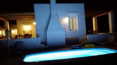 a swimming pool in a house at night at Sea Breeze Villas in Lachania