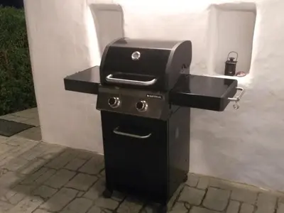 a grill with a sink next to a wall at Sea Breeze Villas in Lachania