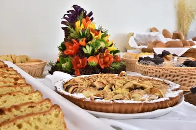 a table with a pie and bread and other foods at Marathon Hotel - All Inclusive in Kolimbia