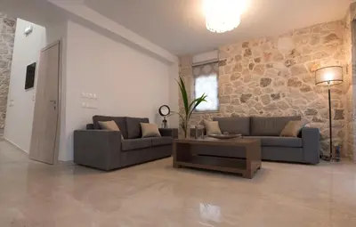 a living room with two couches and a coffee table at Sperveri Enalio Villas - Heated Pool in Kolimbia