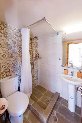 a bathroom with a toilet and a sink at Spitakia in Halki