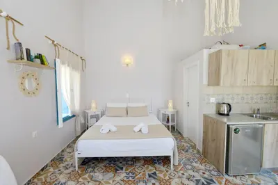 a small room with a bed and a kitchen at Spitakia in Halki