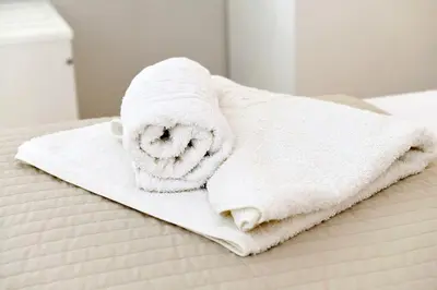 a white towel sitting on top of a bed at Spitakia in Halki