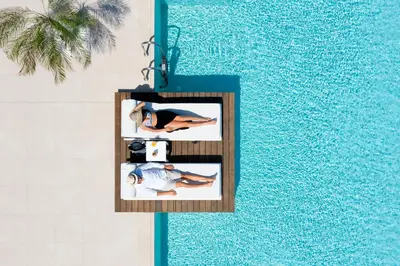 an overhead view of a swimming pool with a picture of two people at Sun Beach Resort in Ialyssos