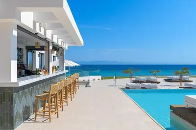 an image of a resort with a swimming pool and the ocean at Sun Beach Resort in Ialyssos