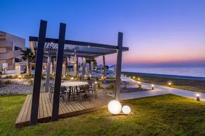 a dining area with a table and a view of the ocean at Sun Beach Resort in Ialyssos