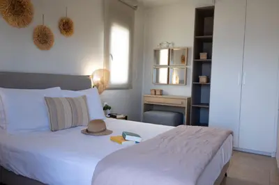 a bedroom with a white bed with a hat on it at Villa Sunrise by the Sea in Kiotari