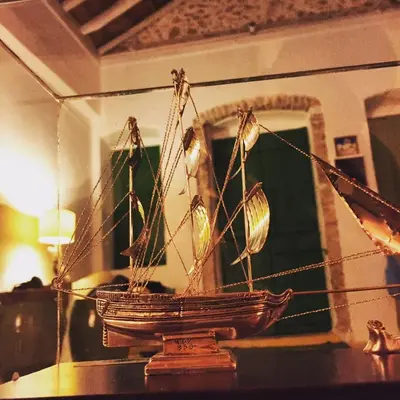a wooden boat on a table in front of a mirror at Hypate, traditional island cottage in Halki