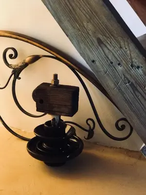 a lamp with a wooden box on top of it at Hypate, traditional island cottage in Halki