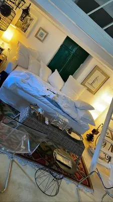 a large bed in a bedroom with a table at Hypate, traditional island cottage in Halki