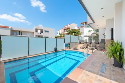 a swimming pool on the balcony of a house at Kiriakos Apartment in Afantou