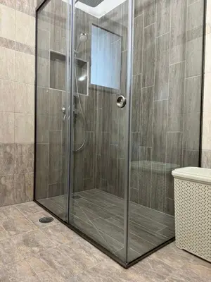 a shower with a glass door in a bathroom at Kiriakos Apartment in Afantou