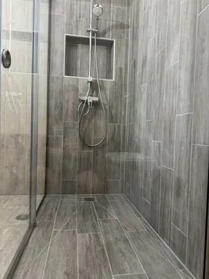 a shower with a shower head in a bathroom at Kiriakos Apartment in Afantou