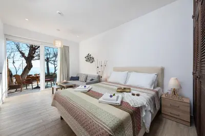 a bedroom with a bed with two towels on it at Stegna Dream in Archangelos