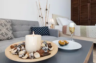 a candle on a table in a living room at Stegna Dream in Archangelos
