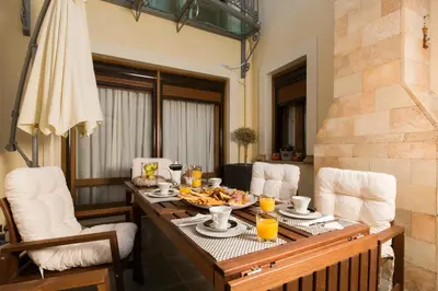 a table with a plate of food on it at Lindos Villa Estelle in Líndos
