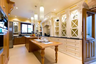 a large kitchen with wooden cabinets and a wooden table at Lindos Villa Estelle in Líndos