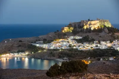 a view of a town on a hill at night at Lindos Villa Estelle in Líndos