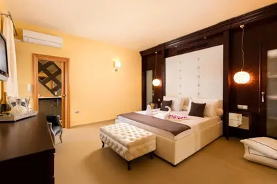 a bedroom with a large bed and a table at Lindos Villa Estelle in Líndos