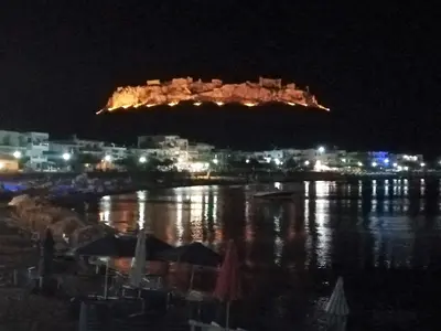 a view of a city at night with the water at Stamatia's House in Haraki