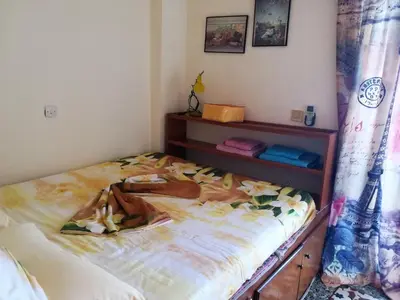 a bedroom with a bed and a dresser with a bed sqor at Stamatia's House in Haraki