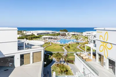 a view of the beach from the balcony of a resort at Asterias Beach Resort in Afantou