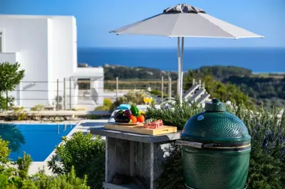 a bowl of fruit on a table next to a pool at Kokinogremos Villa in Kalithies